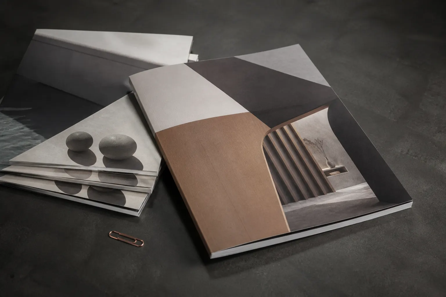 Stack of printed brochures and catalogues from Company Profile Designs